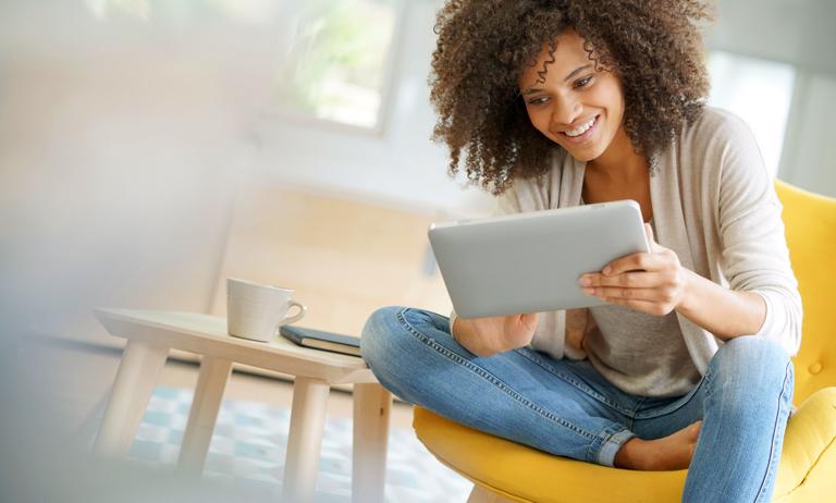 Photo of smiling woman using a tablet